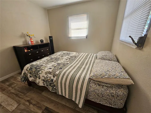 a bedroom with a bed and window