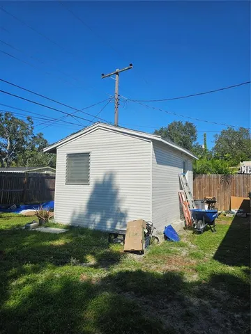 a backyard of a house with table and chairs