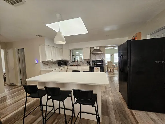 a large kitchen with dining table and chairs