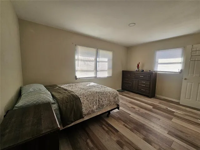 a spacious bedroom with a bed and window