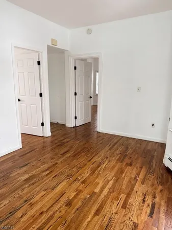 a view of a room with wooden floor