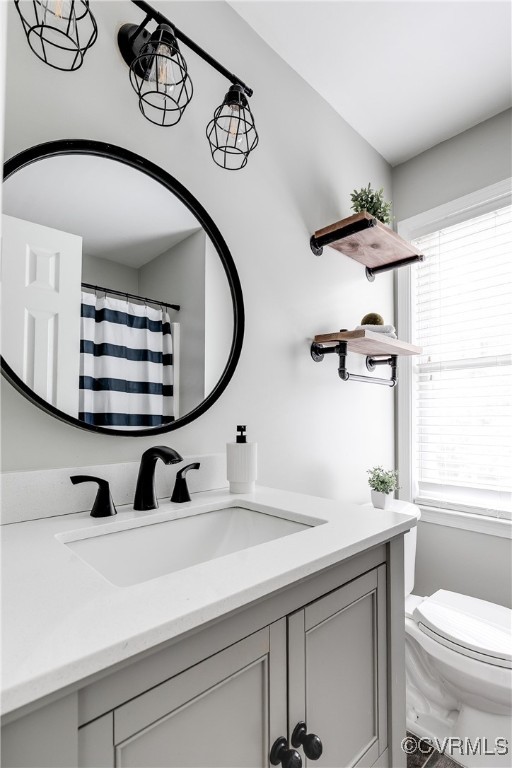 11201 Danforth Road Chesterfield, VA 23838 - Photo 15 of 31 a bathroom with a toilet a sink and mirror