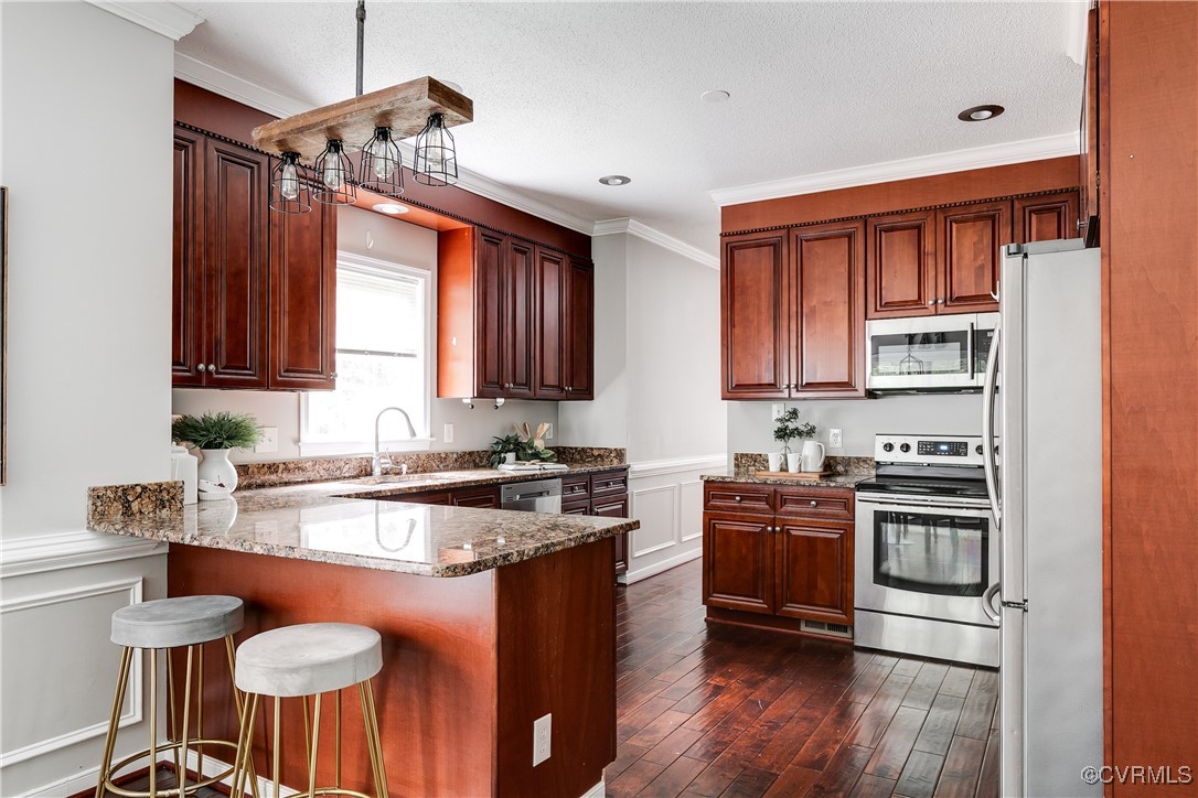 11201 Danforth Road Chesterfield, VA 23838 - Photo 10 of 31 a kitchen with stainless steel appliances granite countertop a stove a sink dishwasher and a refrigerator with wooden floor