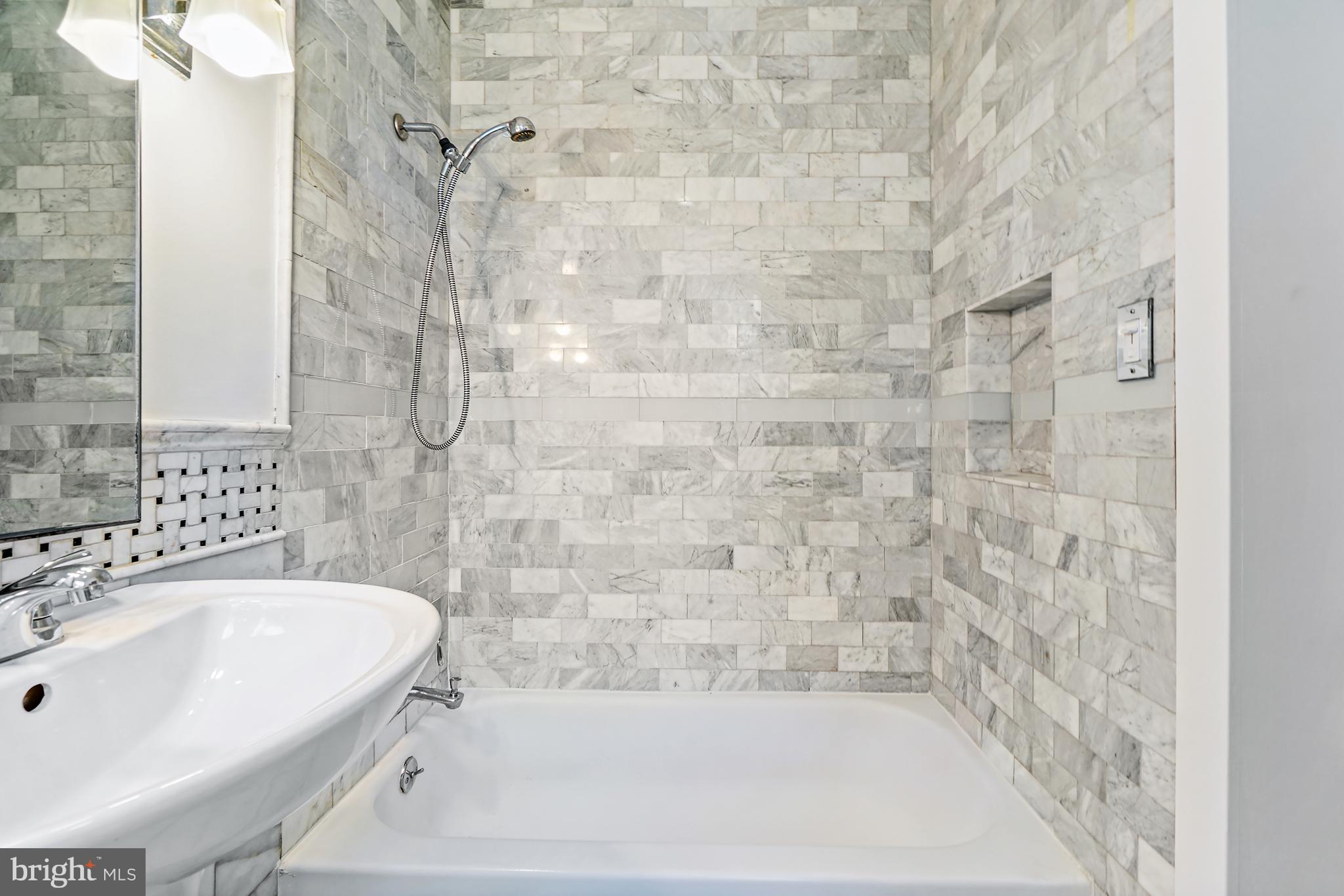 1822 15th Street Northwest, Unit 303 Washington, DC 20009 - Photo 16 of 22 a bathroom with a bathtub and shower