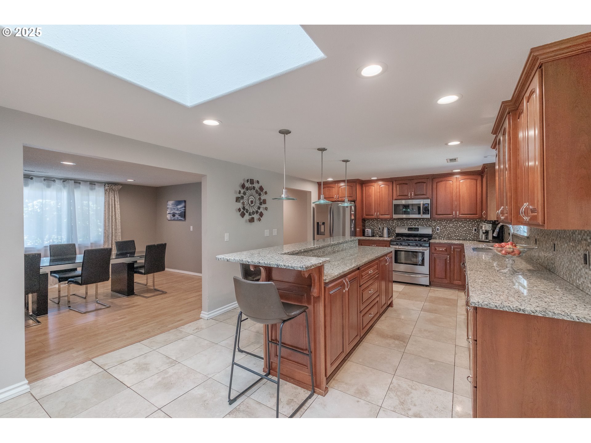 2225 Molalla Road Woodburn, OR 97071 - Photo 32 of 48 a kitchen with stainless steel appliances granite countertop a stove a sink a refrigerator and chairs