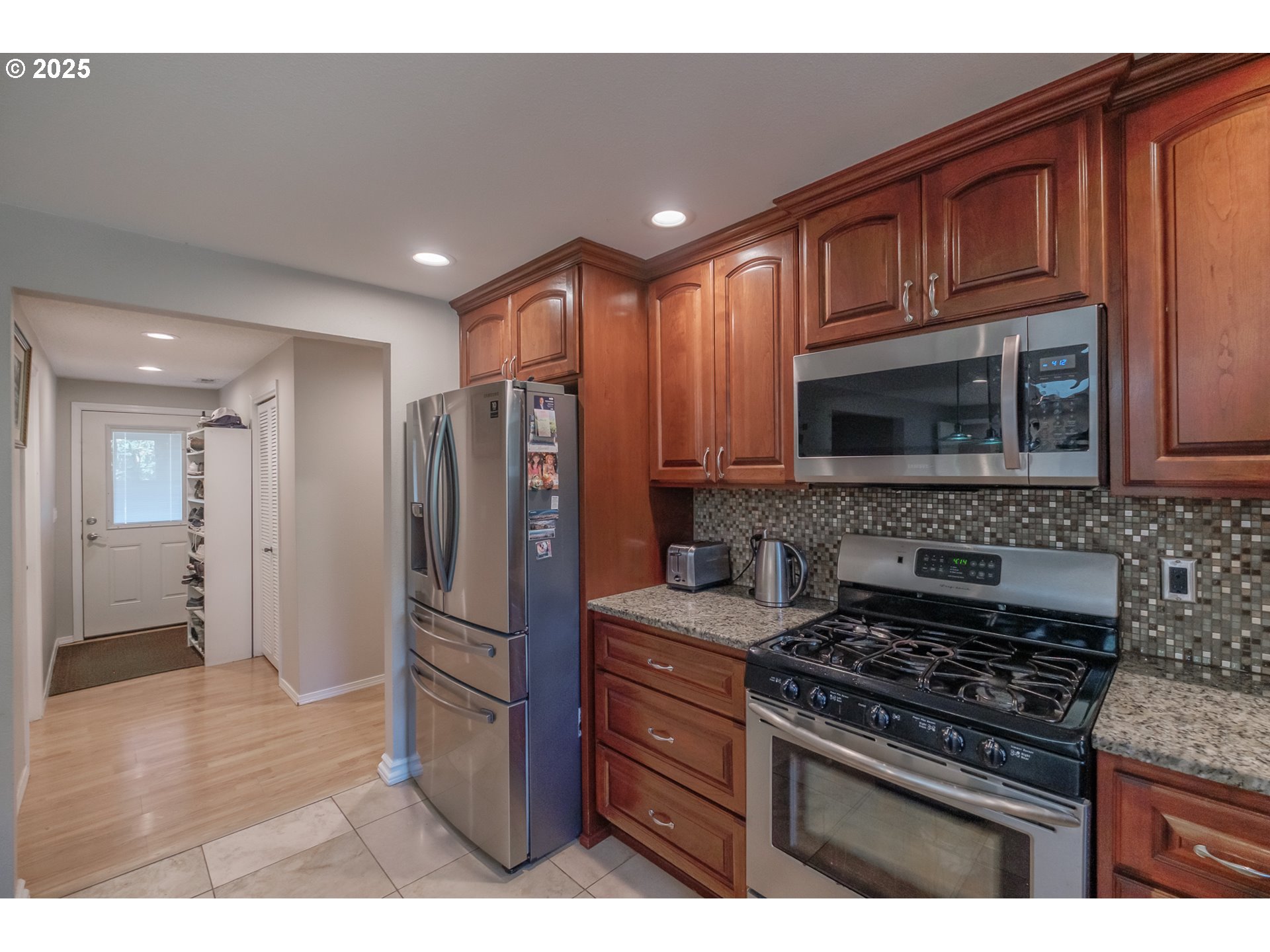 2225 Molalla Road Woodburn, OR 97071 - Photo 35 of 48 a kitchen with stainless steel appliances granite countertop a stove microwave and refrigerator