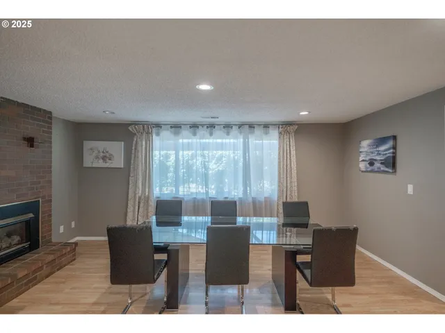 a dining room with furniture and wooden floor