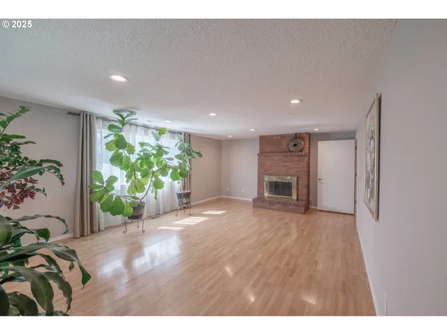 a view of a room with an empty space and a window