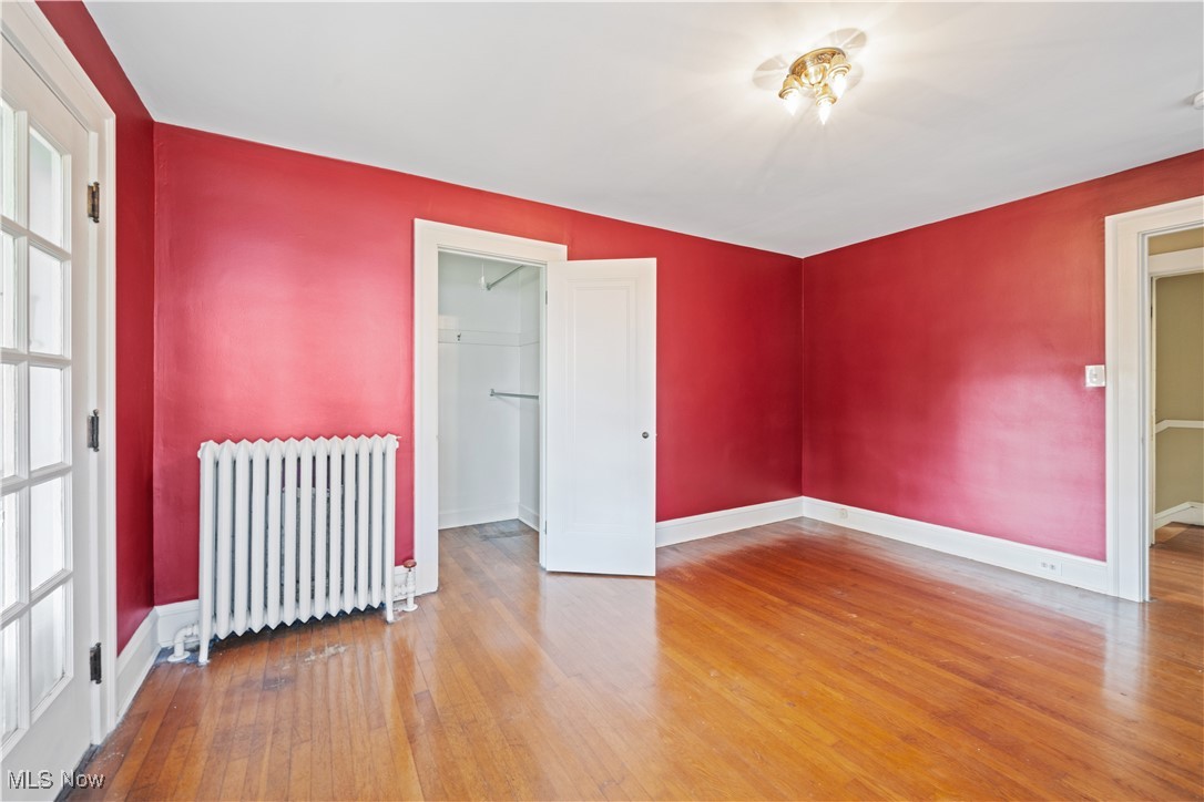 24510 Lake Road Bay Village, OH 44140 - Photo 41 of 45 Unfurnished room featuring radiator and hardwood / wood-style floors