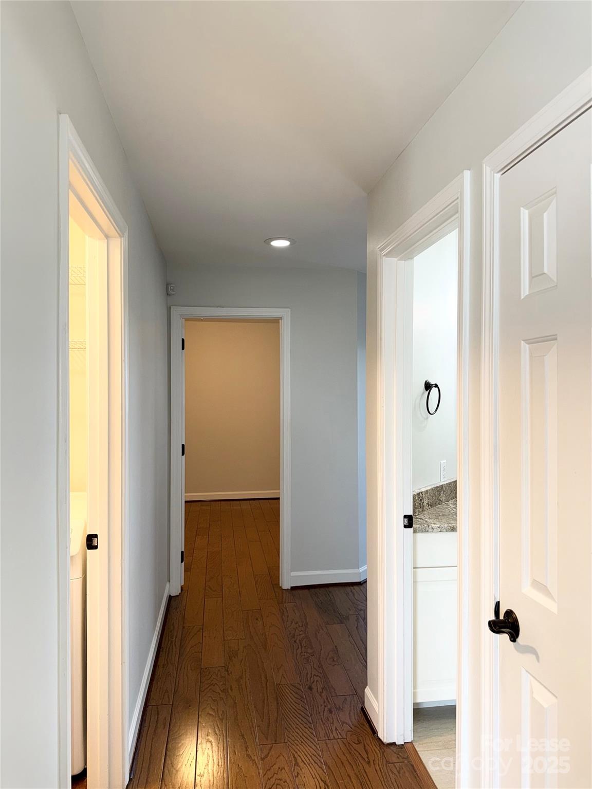 1133 Torrence Circle Davidson, NC 28036 - Photo 25 of 43 a view of a hallway with wooden floor and closet area