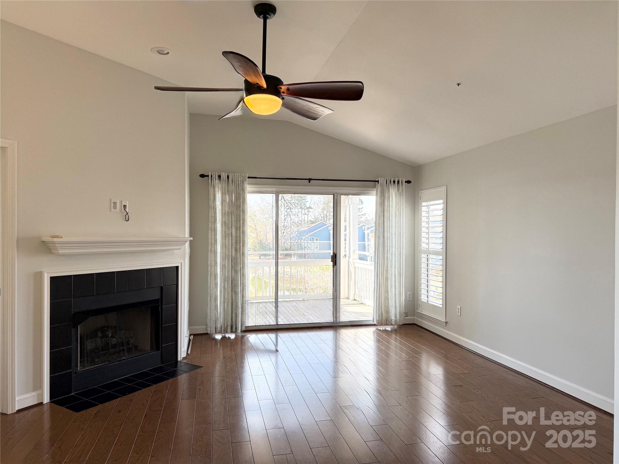 1133 Torrence Circle Davidson, NC 28036 - Photo 29 of 43 a view of an empty room with wooden floor fireplace and a window