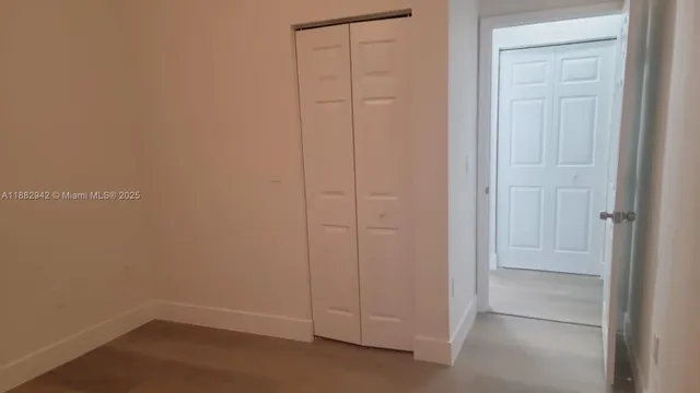 an empty room with closet area