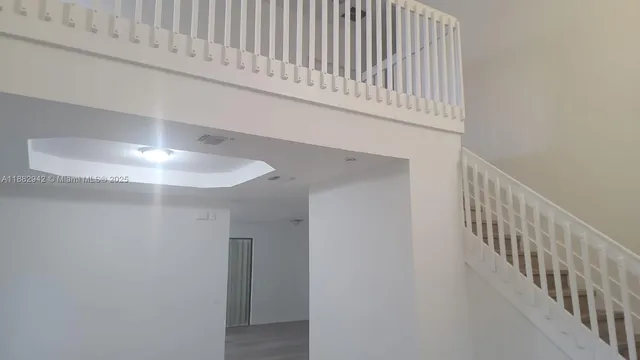 a view of staircase with white walls