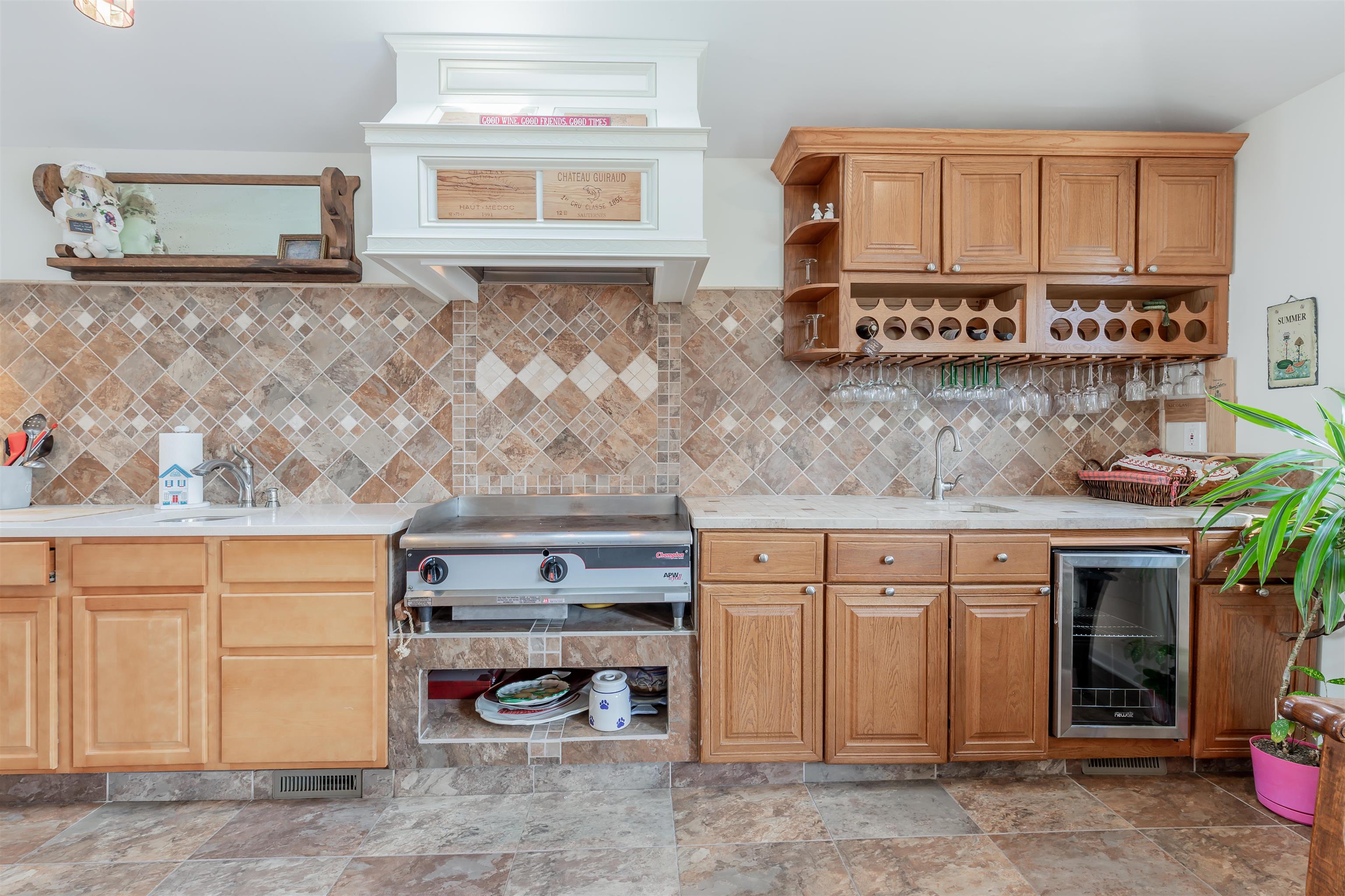 1013 Seashore Road Cape May, NJ 08204 - Photo 11 of 44 a kitchen with stainless steel appliances granite countertop a stove a sink and a microwave
