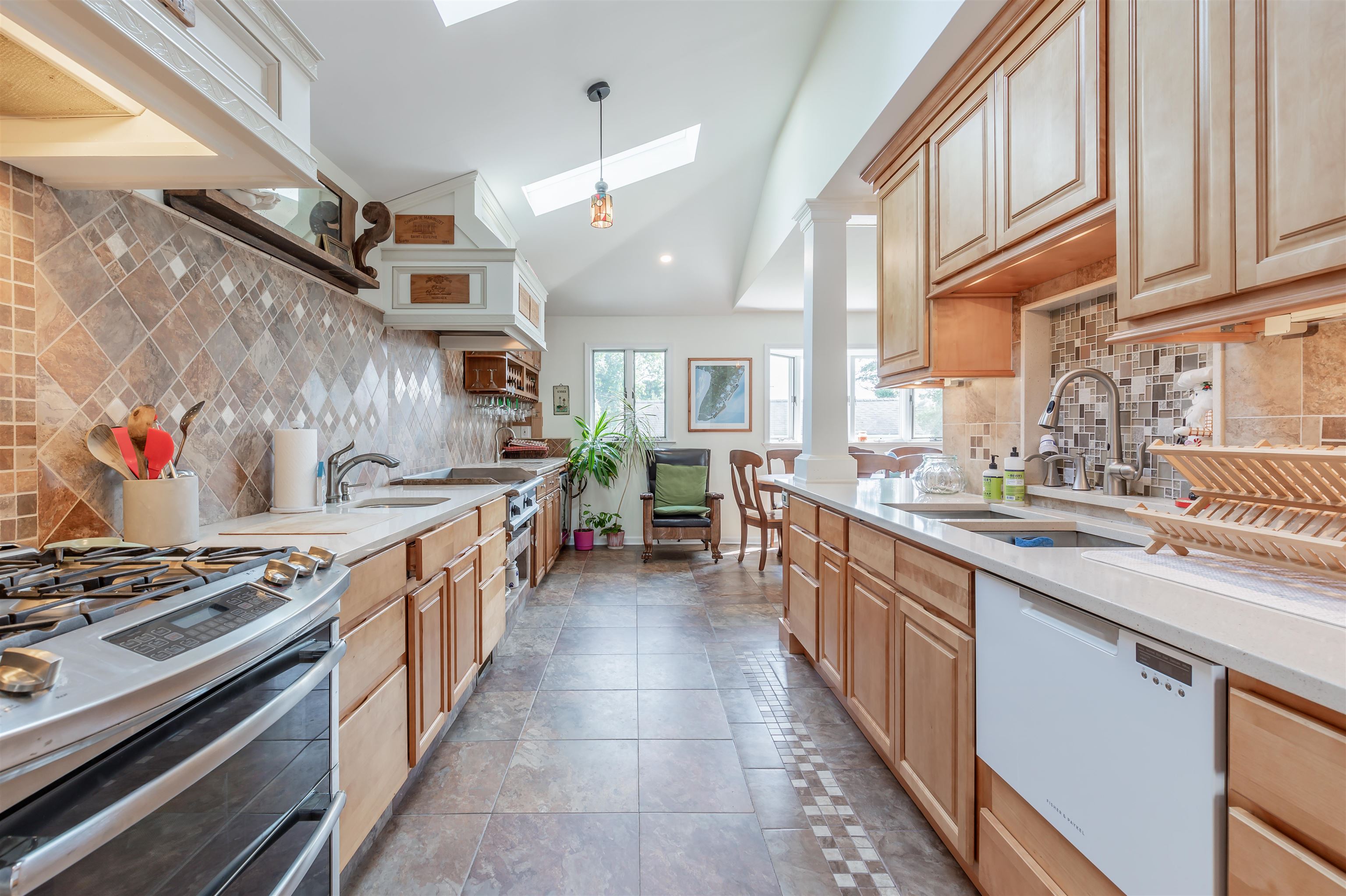 1013 Seashore Road Cape May, NJ 08204 - Photo 14 of 44 a large kitchen with stainless steel appliances granite countertop a stove and a sink