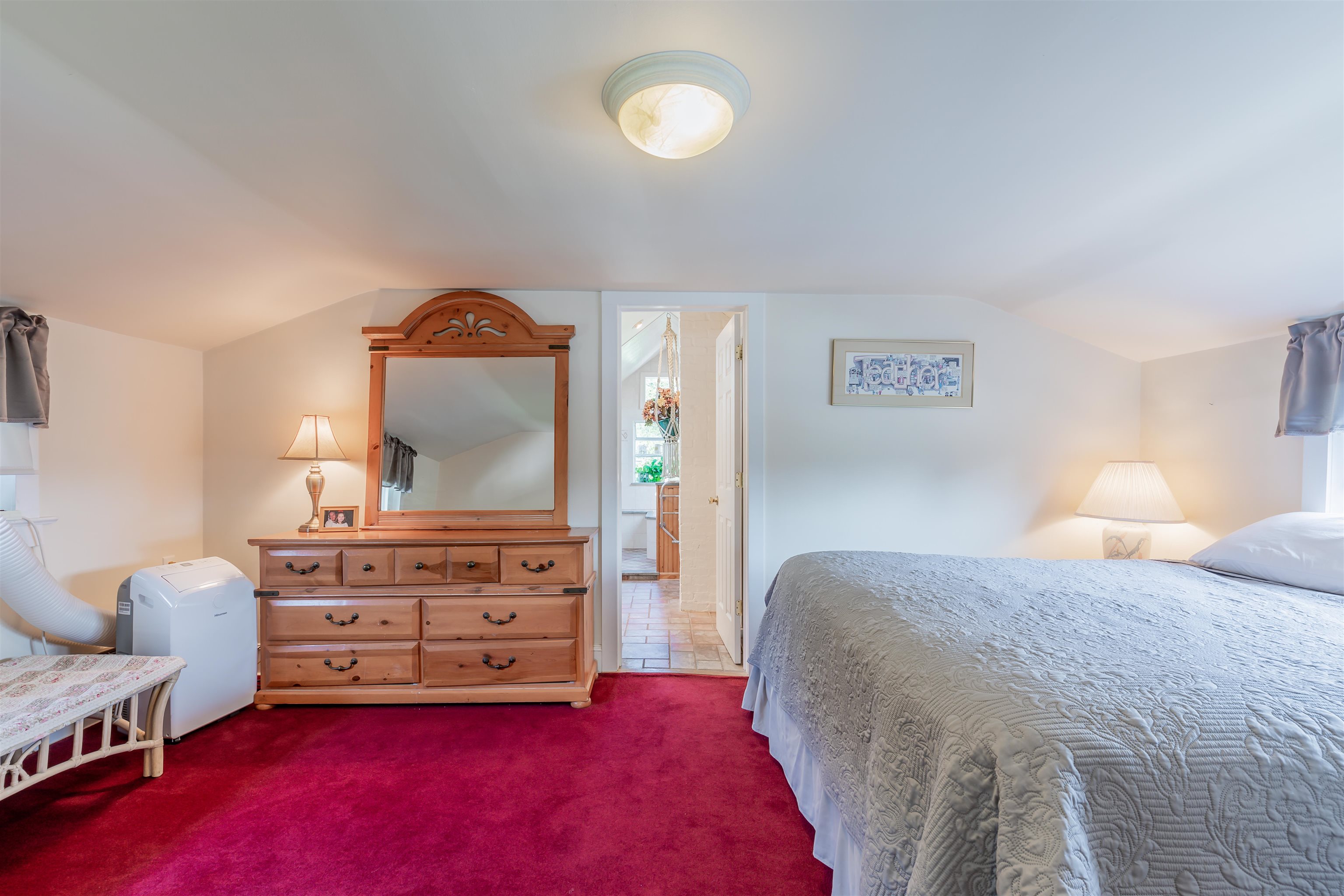 1013 Seashore Road Cape May, NJ 08204 - Photo 30 of 44 a bedroom with a bed and a chandelier