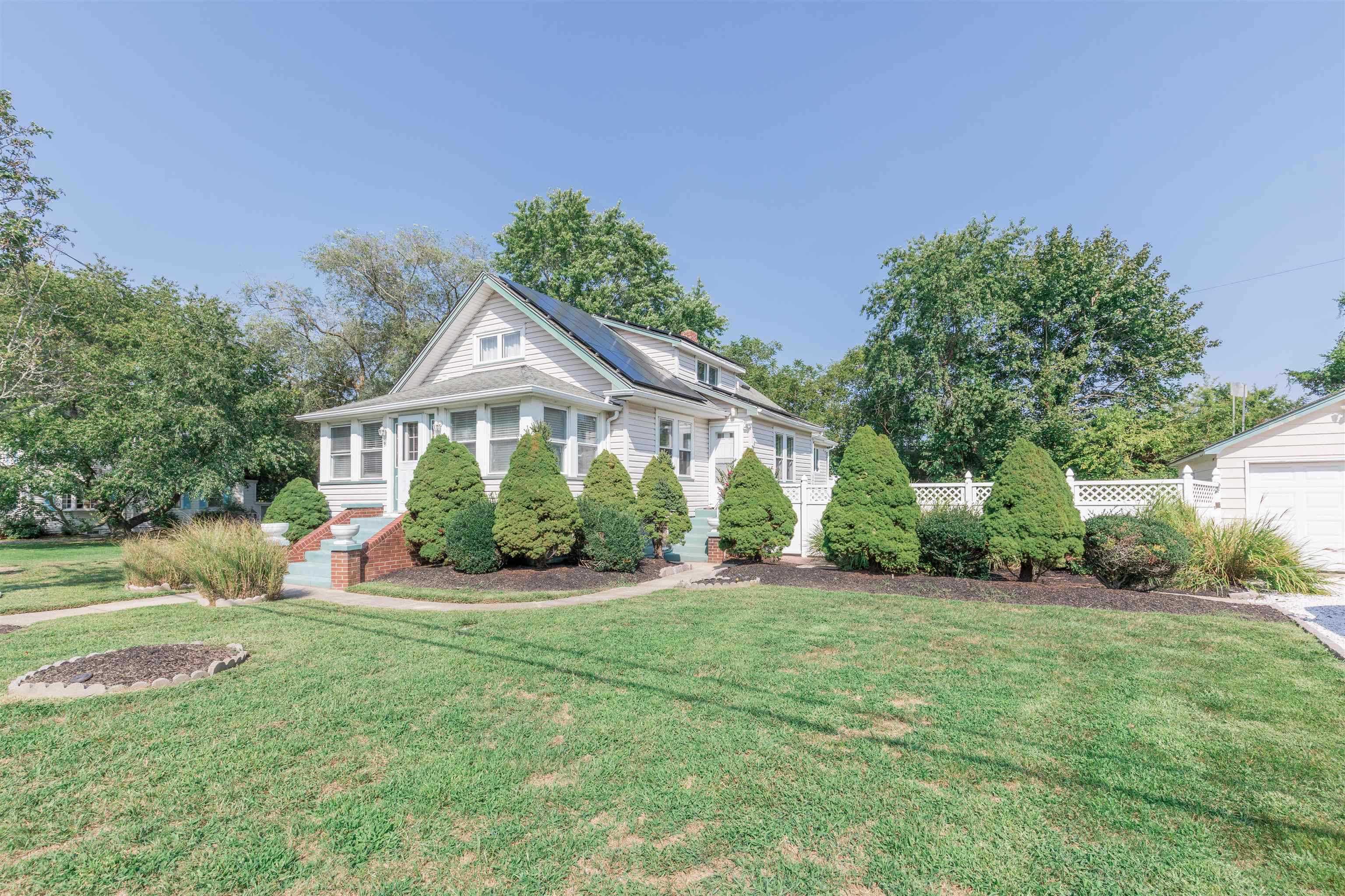1013 Seashore Road Cape May, NJ 08204 - Photo 43 of 44 a front view of a house with a yard and potted plants