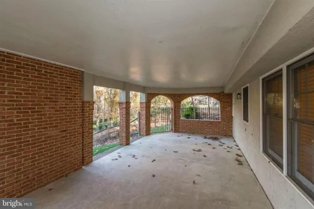 a big room with wooden floor and windows