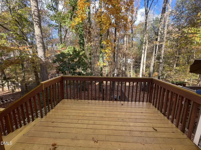 a view of a house with barbeque and wooden floor
