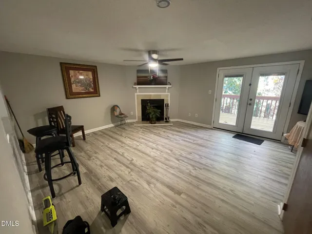 a view of a livingroom with wooden floor and staircase