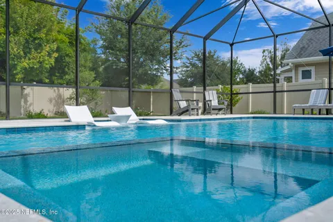 an aerial view of a house with outdoor space and lake view