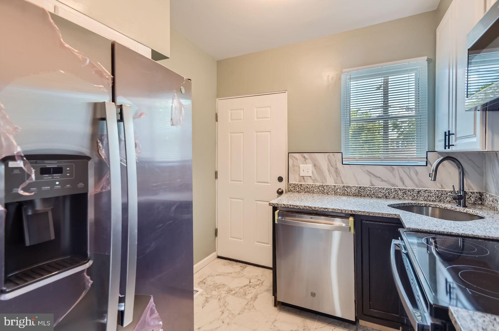 3617 Manchester Avenue Baltimore, MD 21215 - Photo 11 of 28 a kitchen with a sink stove and refrigerator