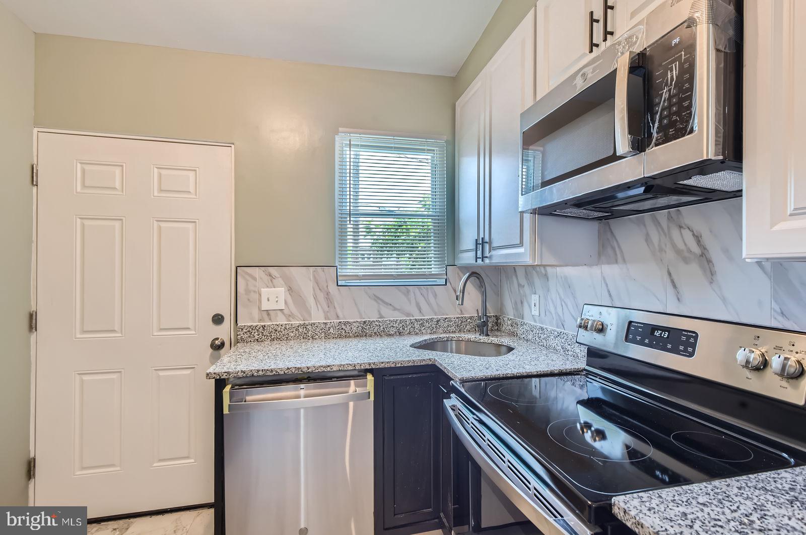 3617 Manchester Avenue Baltimore, MD 21215 - Photo 12 of 28 a kitchen with a stove and a sink