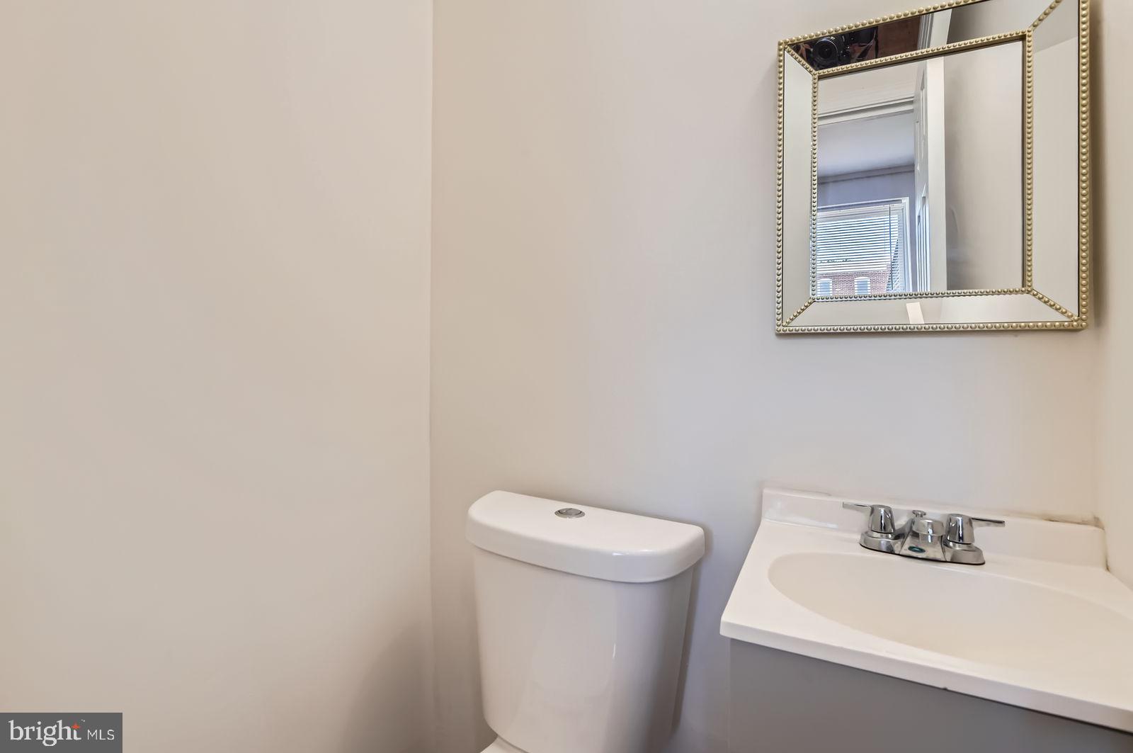 3617 Manchester Avenue Baltimore, MD 21215 - Photo 14 of 28 a bathroom with a sink and a toilet