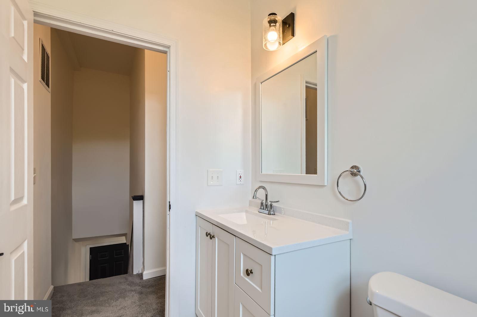 3617 Manchester Avenue Baltimore, MD 21215 - Photo 18 of 28 a bathroom with a sink vanity and mirror