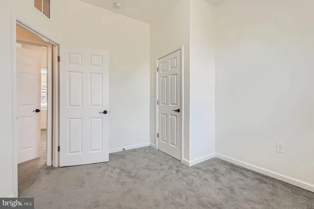 a view of a room with wooden floor and white walls