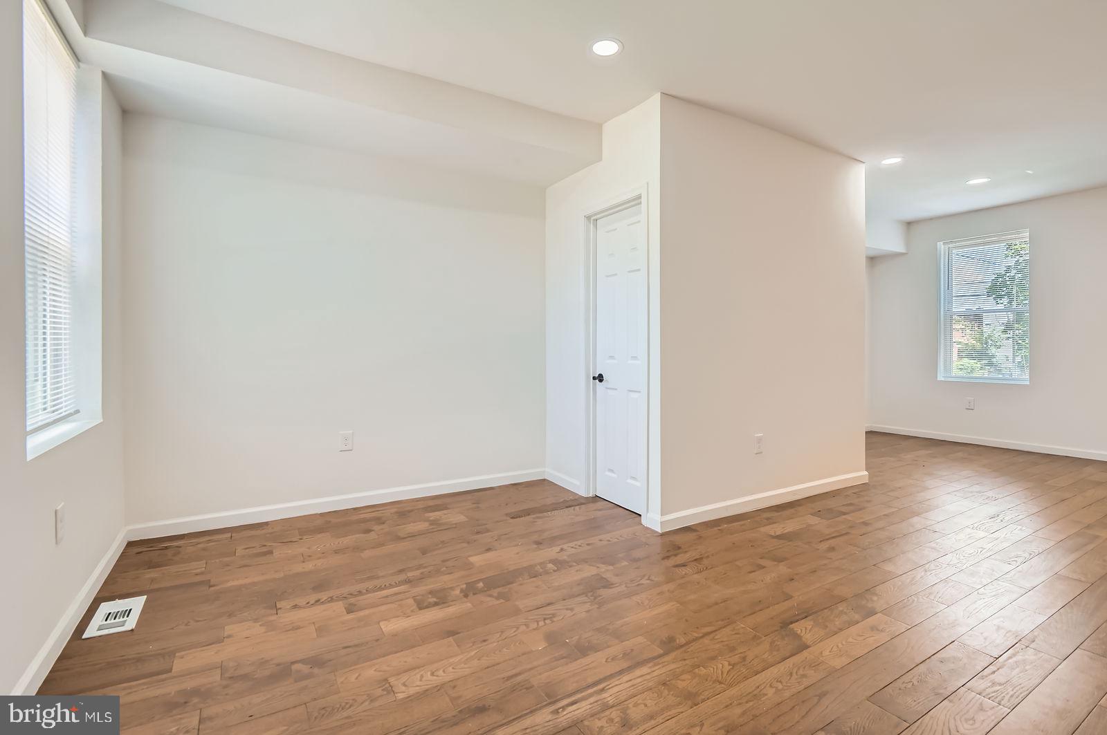 3617 Manchester Avenue Baltimore, MD 21215 - Photo 6 of 28 a view of an empty room with wooden floor and a window