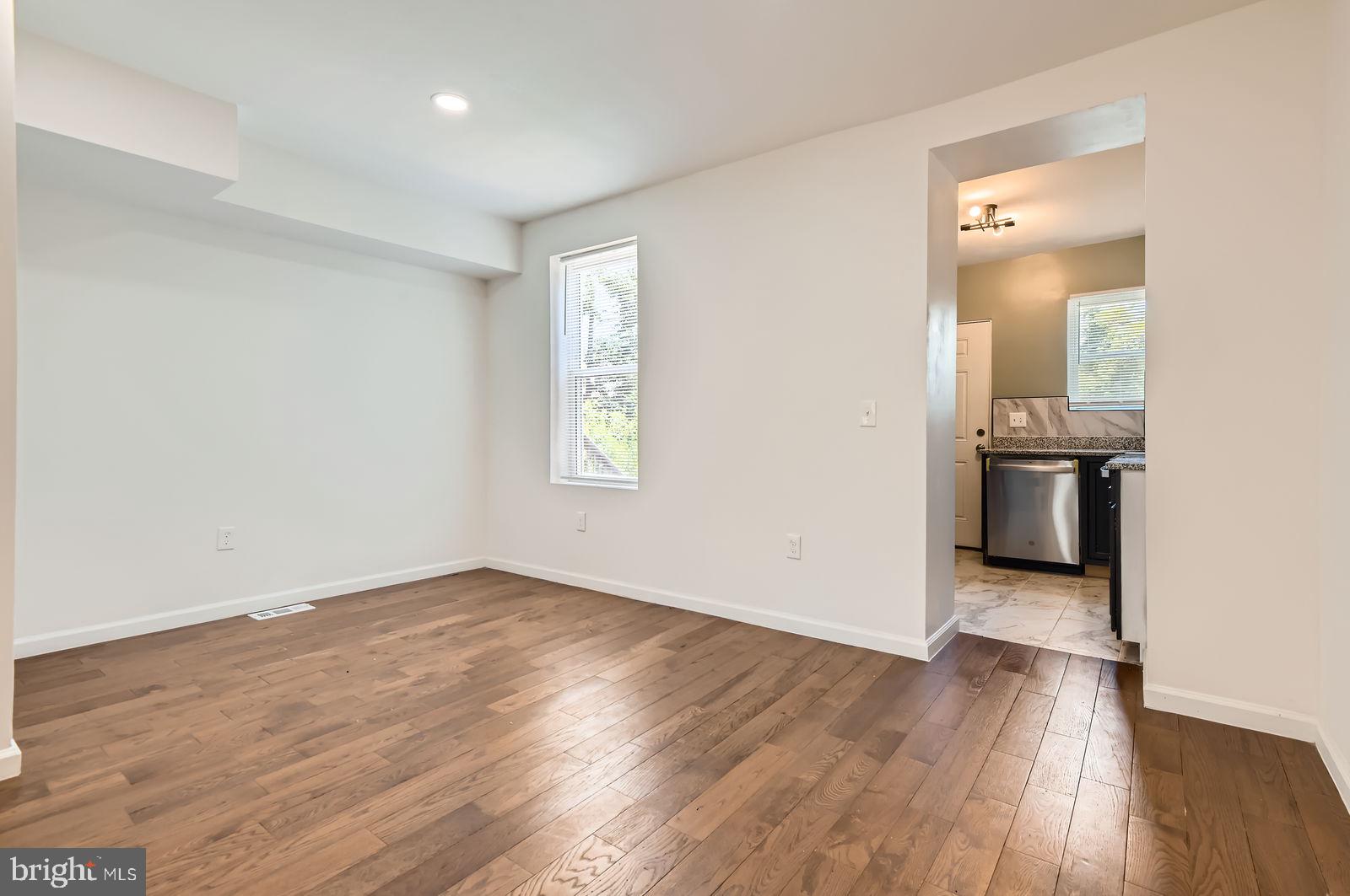 3617 Manchester Avenue Baltimore, MD 21215 - Photo 9 of 28 an empty room with wooden floor and windows