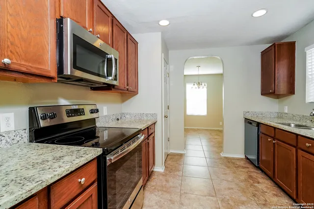 a kitchen with stainless steel appliances granite countertop a sink and a stove