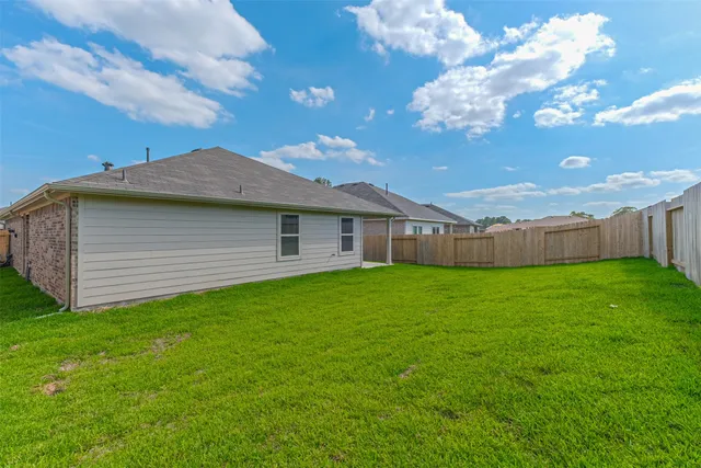 a view of a house with a backyard