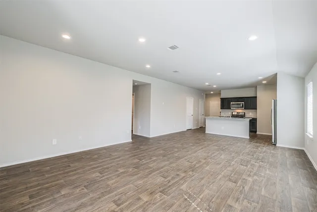 a view of a kitchen with a sink and a refrigerator