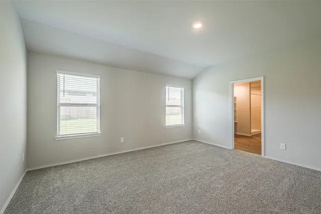 an empty room with windows and closet