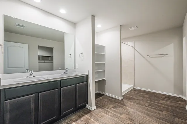 a bathroom with a double vanity sink and mirror