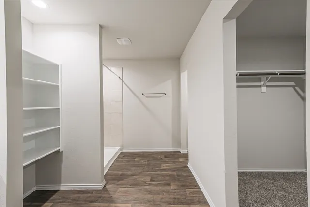 a view of hallway with stairs and wooden floor