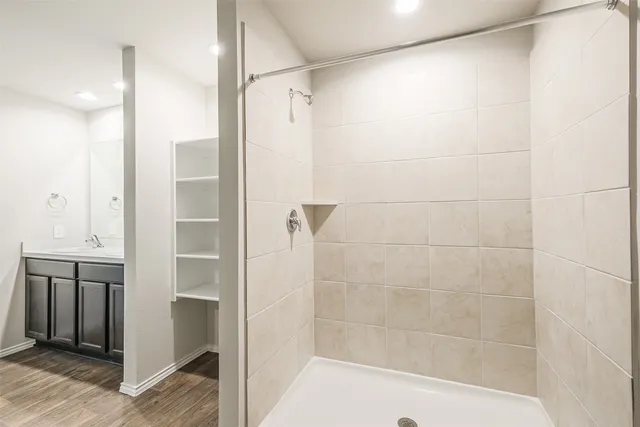 a bathroom with a shower and a glass door