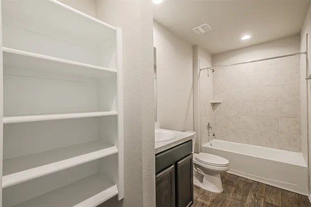 a bathroom with a shower a toilet and a bathtub