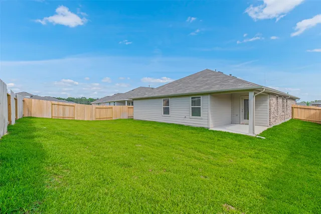 a view of a house with a backyard