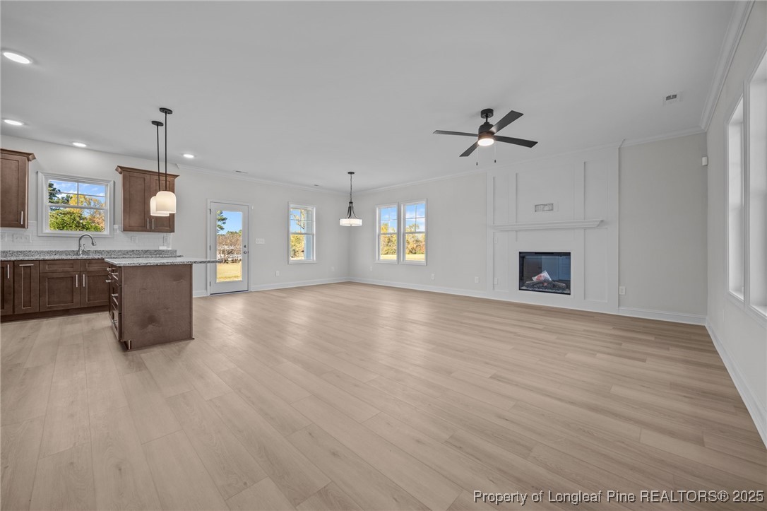 3162 Cameron Hill Road Cameron, NC 28326 - Photo 13 of 45 a view of an empty room with a kitchen and a fireplace