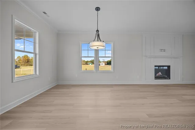 a view of an empty room with window and cabinet
