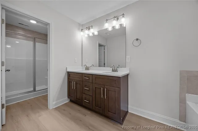 a bathroom with a double vanity sink mirror and shower