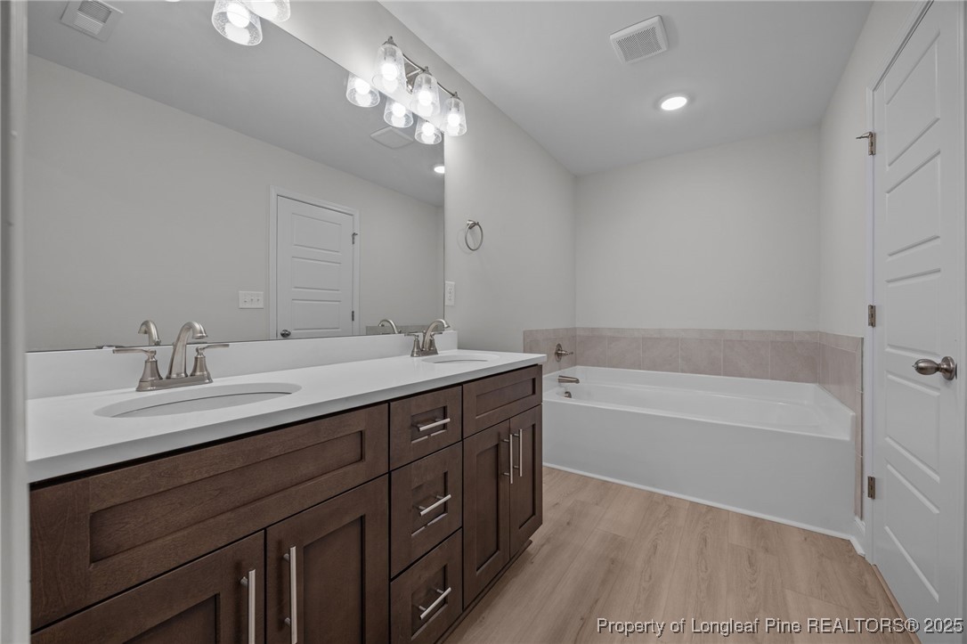 3162 Cameron Hill Road Cameron, NC 28326 - Photo 22 of 45 a bathroom with a tub double sink and mirror