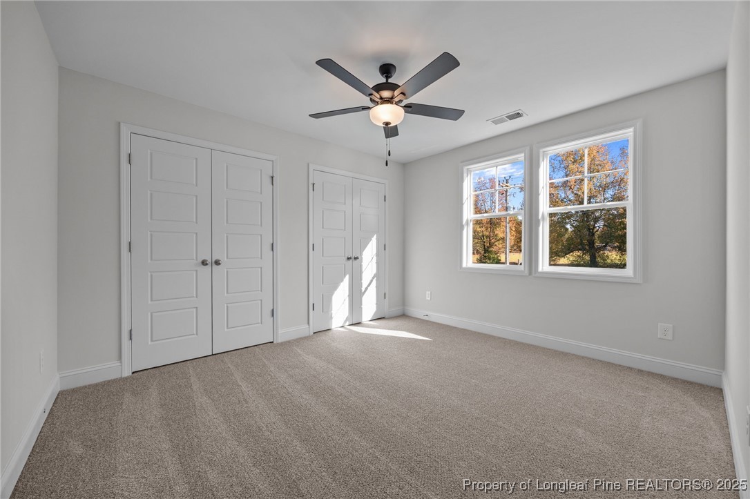 3162 Cameron Hill Road Cameron, NC 28326 - Photo 25 of 45 a view of an empty room with a ceiling fan and window