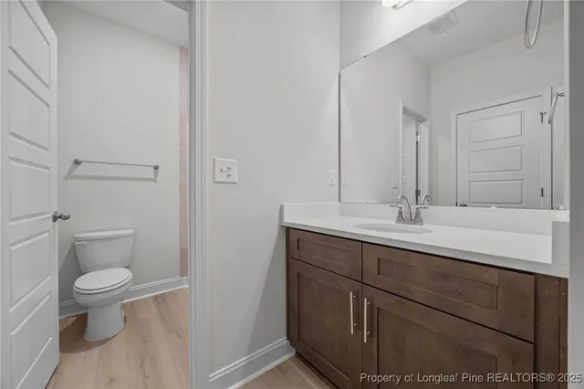 a bathroom with a sink toilet and a mirror