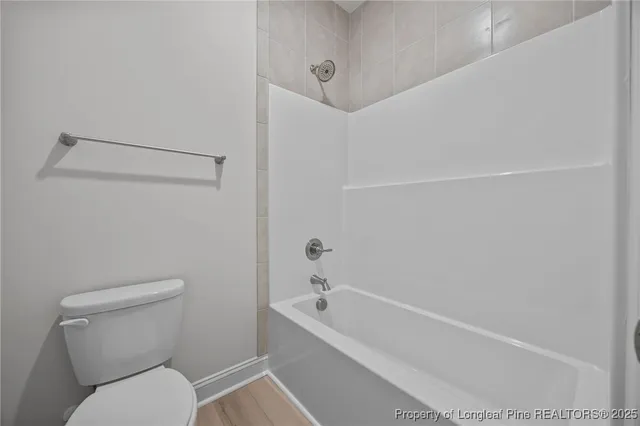 a bathroom with a toilet and a bathtub