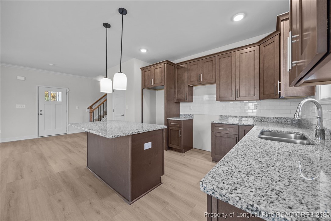 3162 Cameron Hill Road Cameron, NC 28326 - Photo 9 of 45 a kitchen with stainless steel appliances granite countertop a sink a stove and a wooden floors