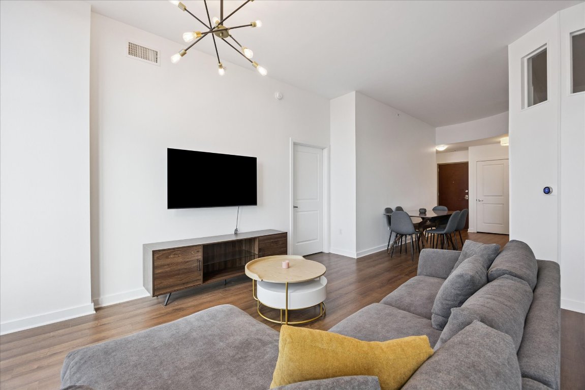 360 Nueces Street, Unit 2704 Austin, TX 78701 - Photo 11 of 40 a living room with furniture and a flat screen tv